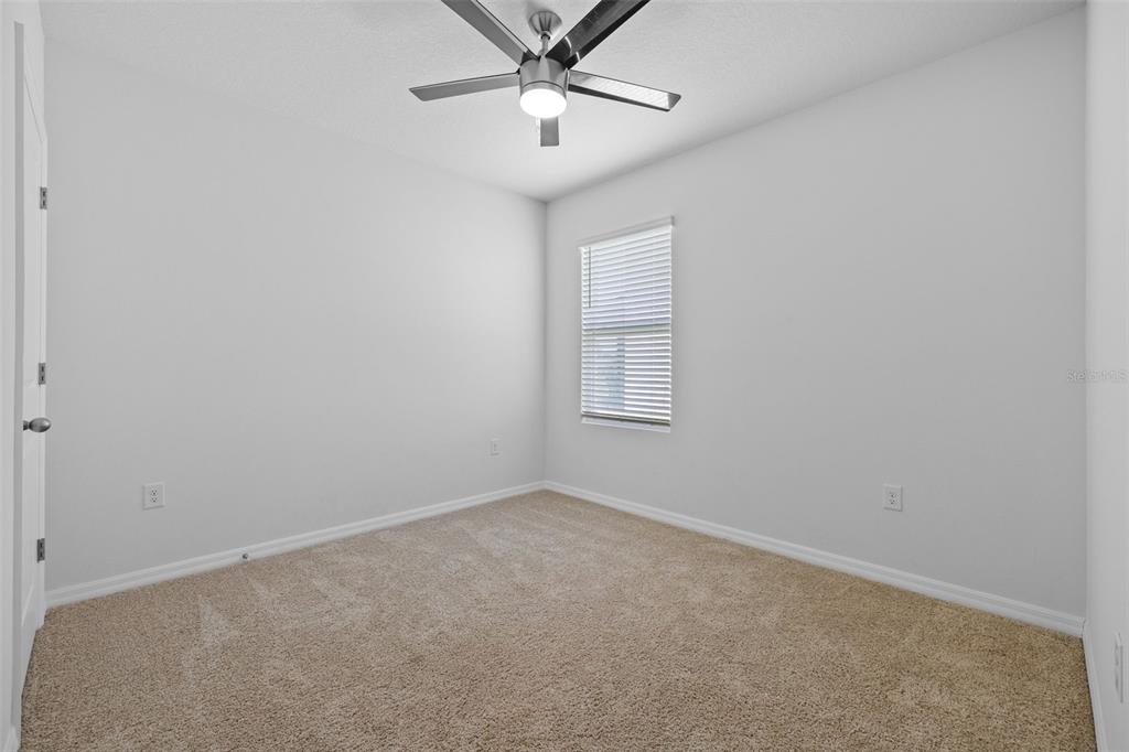 2721 Greenleaf Terrace Parrish, FL 34219 - Photo 15 of 65 an empty room with windows and fan