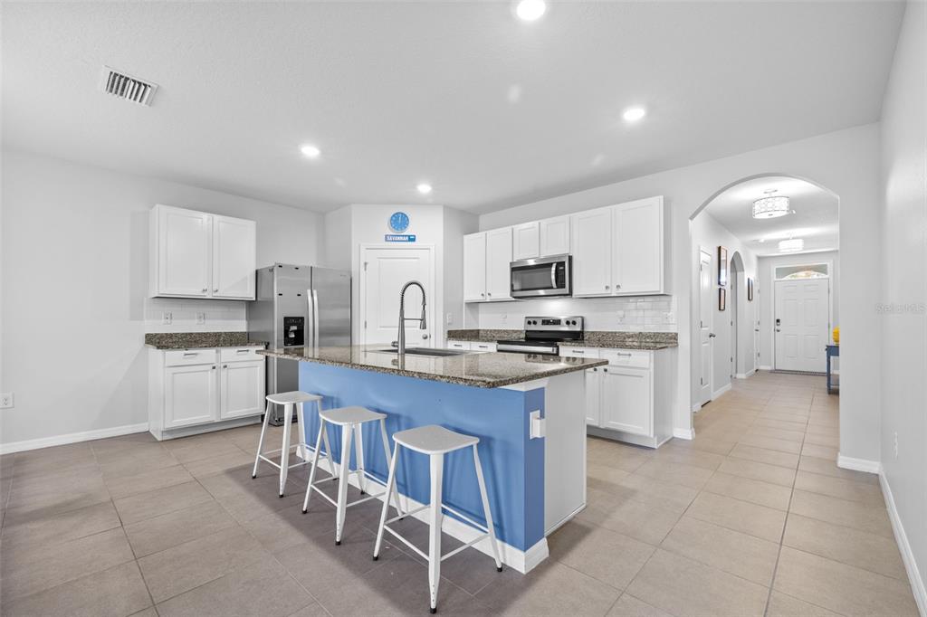 2721 Greenleaf Terrace Parrish, FL 34219 - Photo 2 of 65 a kitchen with refrigerator and cabinets