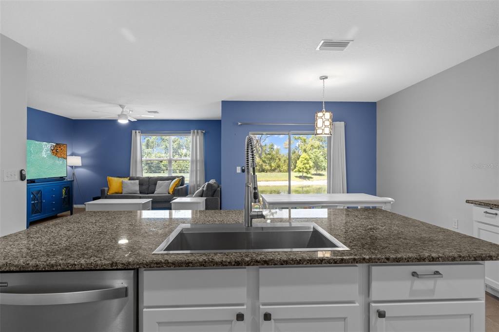 2721 Greenleaf Terrace Parrish, FL 34219 - Photo 25 of 65 a kitchen with granite countertop kitchen island sink and windows