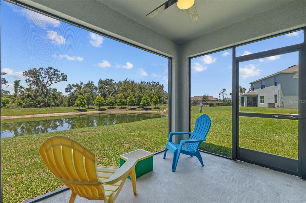 2721 Greenleaf Terrace Parrish, FL 34219 - Photo 39 of 65 a view of a swimming pool with a lounge chairs and a lake view