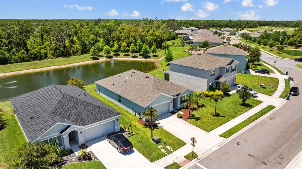 2721 Greenleaf Terrace Parrish, FL 34219 - Photo 62 of 65 an aerial view of a house with a garden and lake view