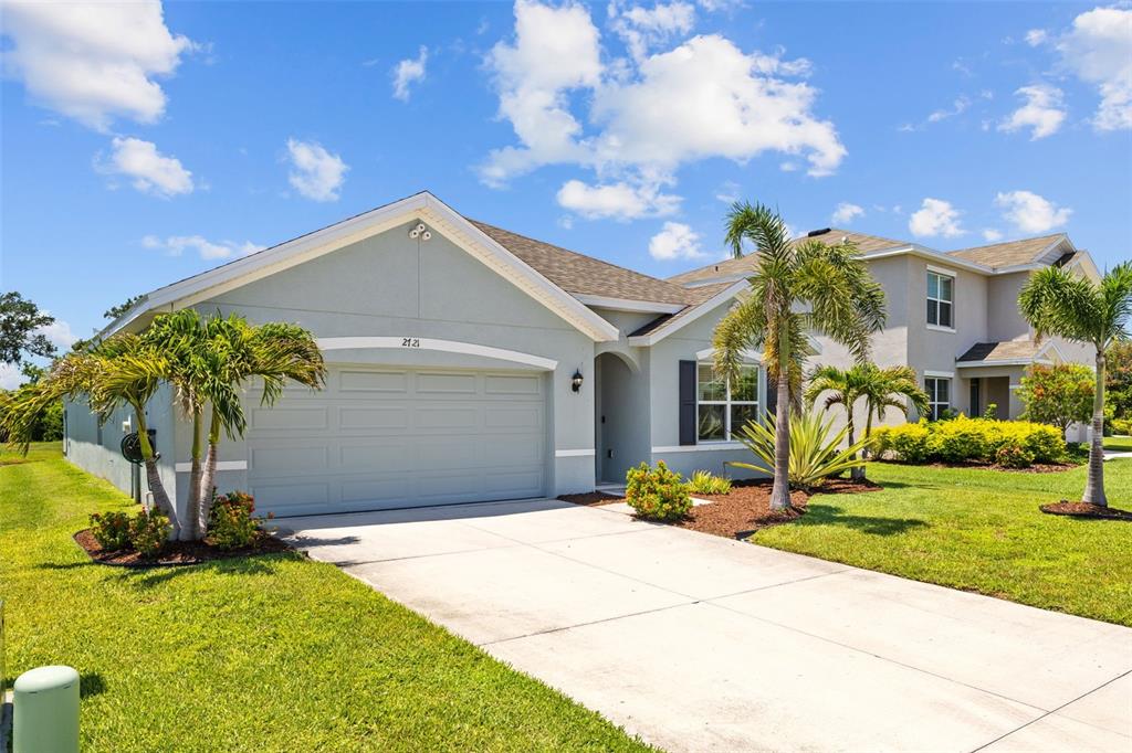 2721 Greenleaf Terrace Parrish, FL 34219 - Photo 7 of 65 a front view of a house with a yard and garage