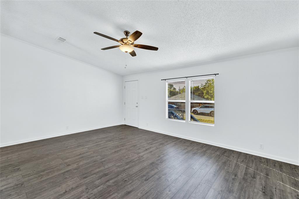 312 6th Street Joshua, TX 76058 - Photo 12 of 33 a view of empty room with wooden floor and fan