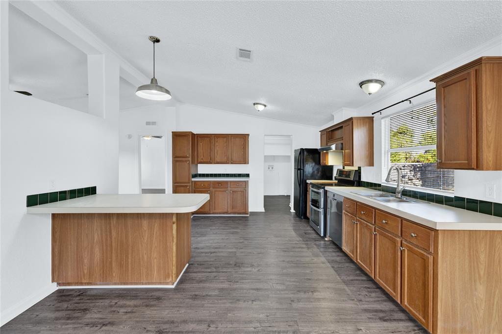 312 6th Street Joshua, TX 76058 - Photo 15 of 33 a kitchen with stainless steel appliances a sink stove and cabinets