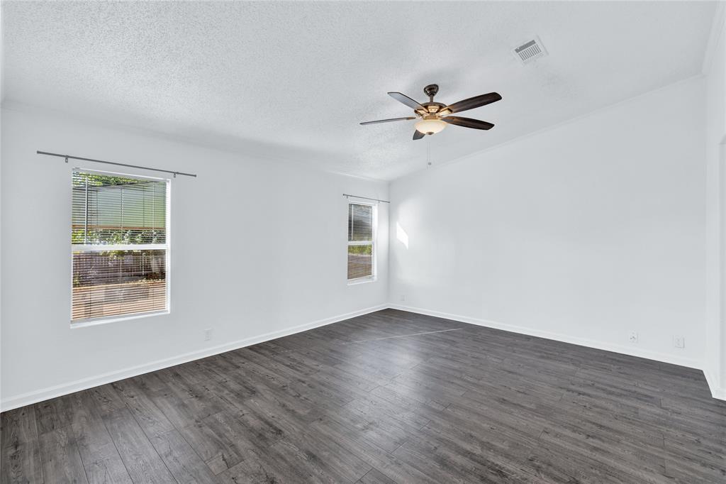 312 6th Street Joshua, TX 76058 - Photo 18 of 33 an empty room with wooden floor ceiling fan and window