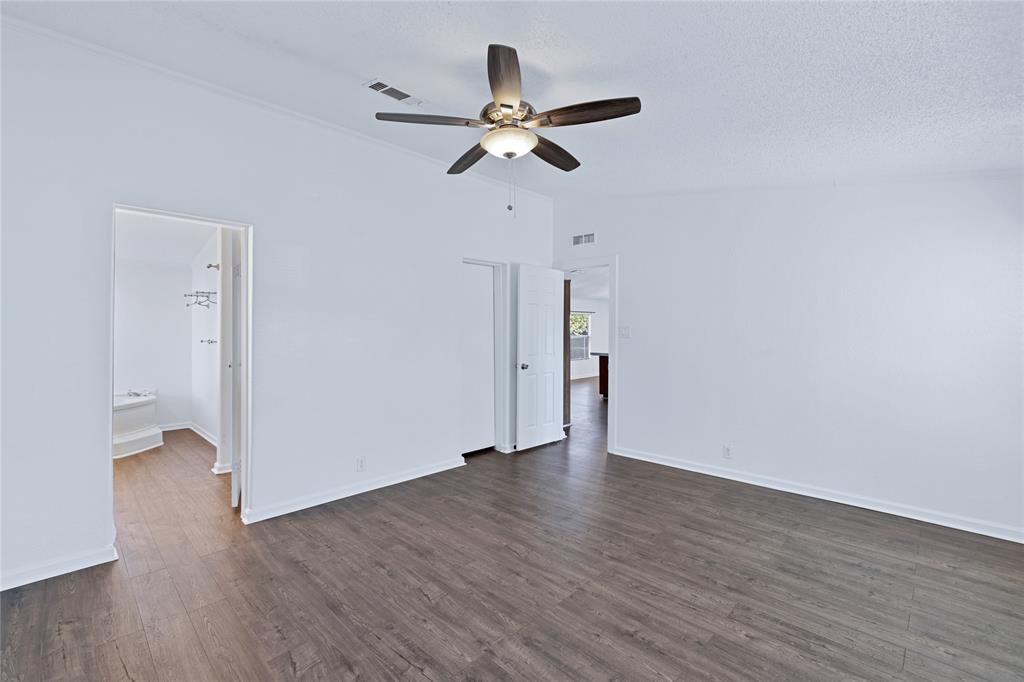 312 6th Street Joshua, TX 76058 - Photo 19 of 33 a view of an empty room with wooden floor and a ceiling fan