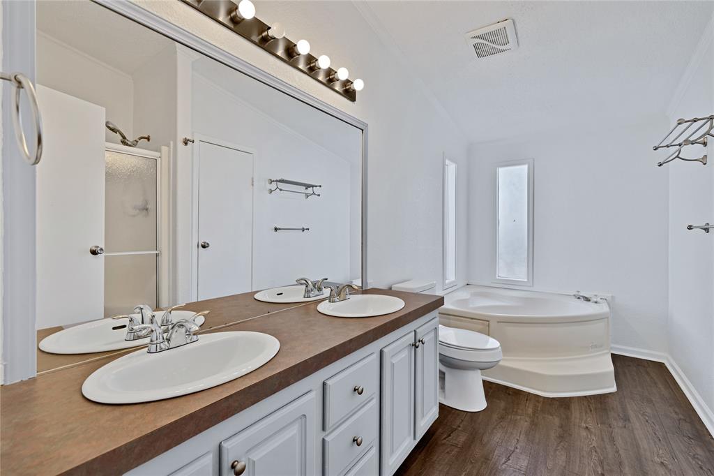 312 6th Street Joshua, TX 76058 - Photo 20 of 33 a bathroom with a double vanity sink toilet and mirror