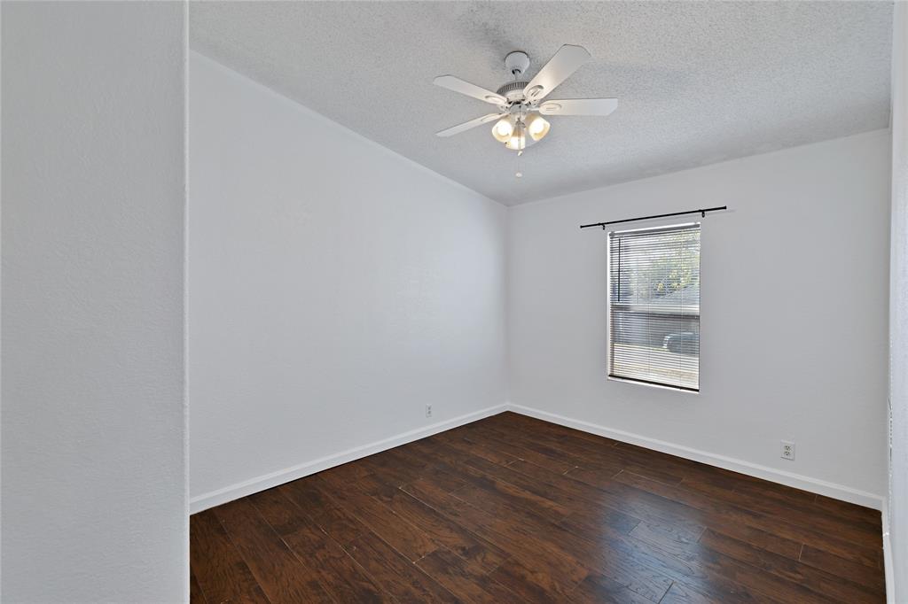 312 6th Street Joshua, TX 76058 - Photo 22 of 33 a view of an empty room with wooden floor and a window