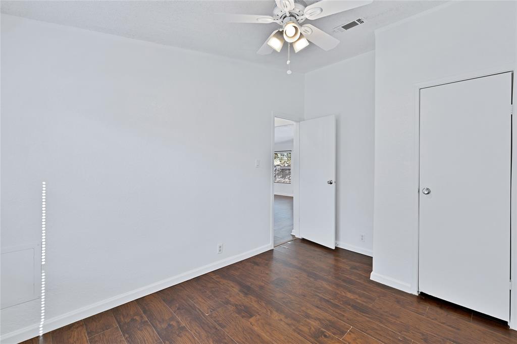 312 6th Street Joshua, TX 76058 - Photo 23 of 33 an empty room with wooden floor and ceiling fan