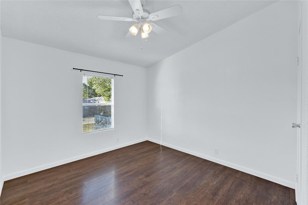 312 6th Street Joshua, TX 76058 - Photo 24 of 33 an empty room with wooden floor and windows