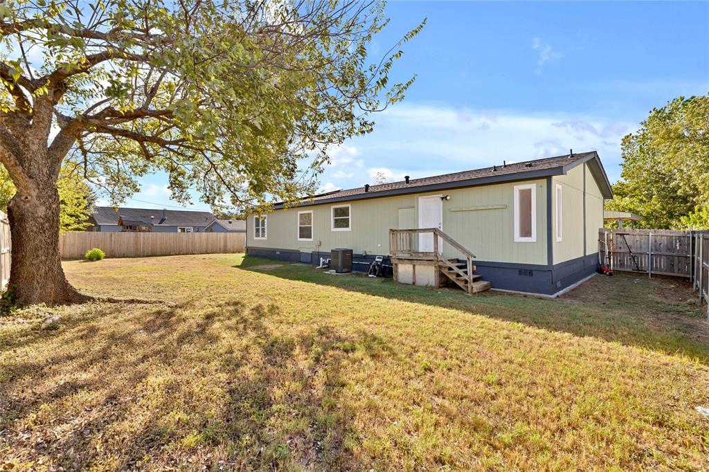 312 6th Street Joshua, TX 76058 - Photo 26 of 33 a view of a backyard with a large tree