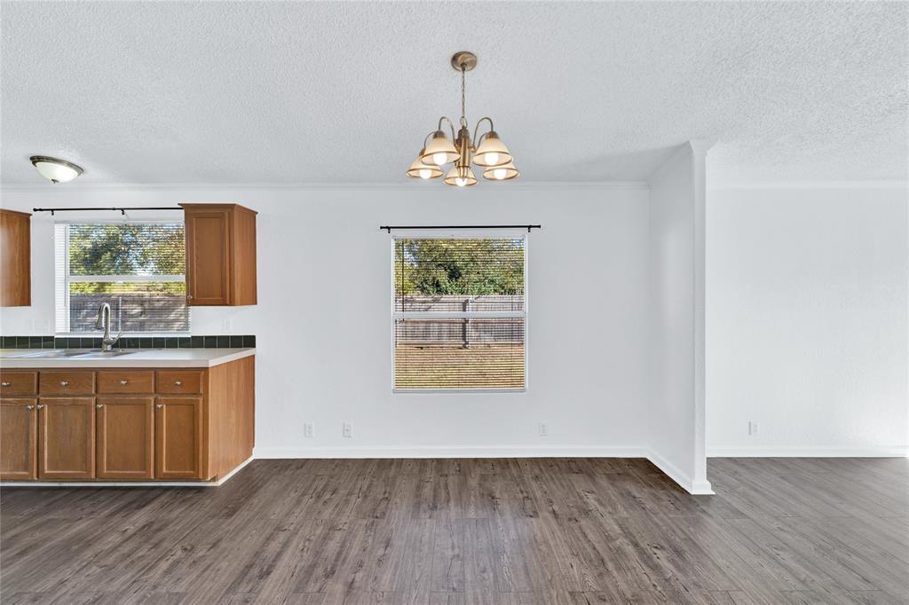 312 6th Street Joshua, TX 76058 - Photo 5 of 33 a view of an empty room with wooden floor and a window