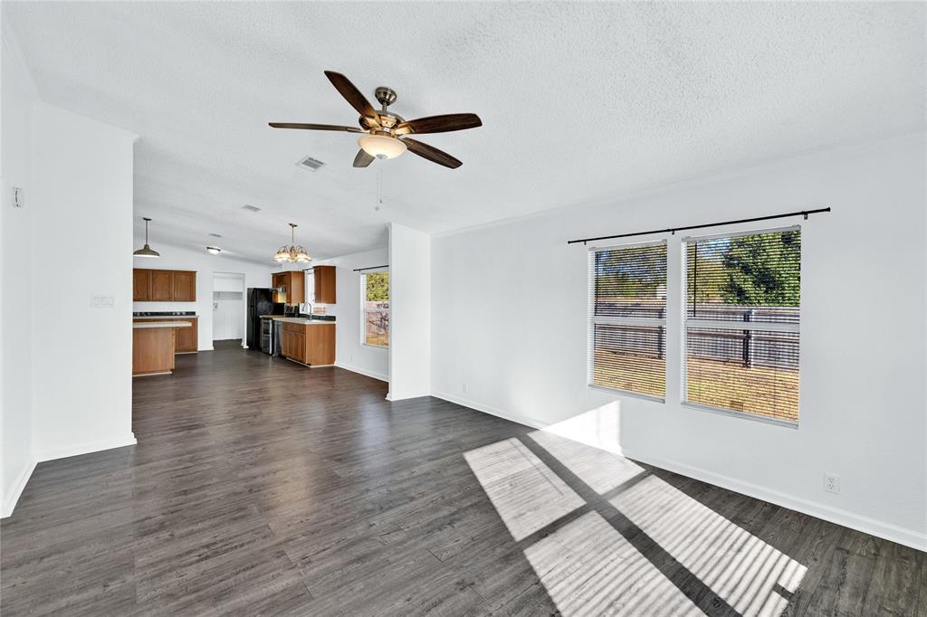 312 6th Street Joshua, TX 76058 - Photo 7 of 33 a view of an empty room with a window and wooden floor
