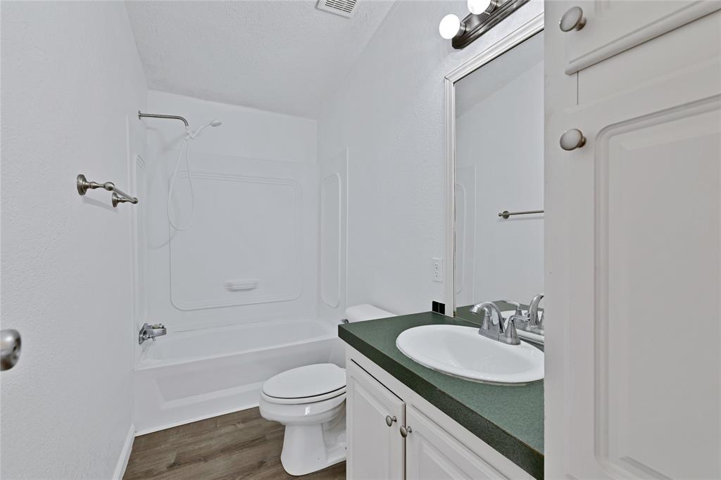 312 6th Street Joshua, TX 76058 - Photo 9 of 33 a bathroom with a sink toilet a vanity and shower