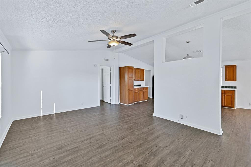 312 6th Street Joshua, TX 76058 - Photo 10 of 33 a view of an empty room with a window and wooden floor