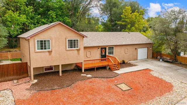 a backyard of a house with barbeque oven table and chairs