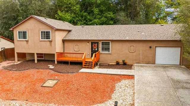 a backyard of a house with barbeque oven