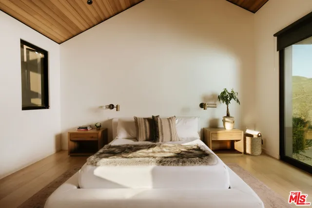 a bedroom with furniture and a potted plant