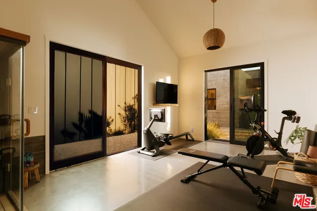 a view of a livingroom with gym equipment