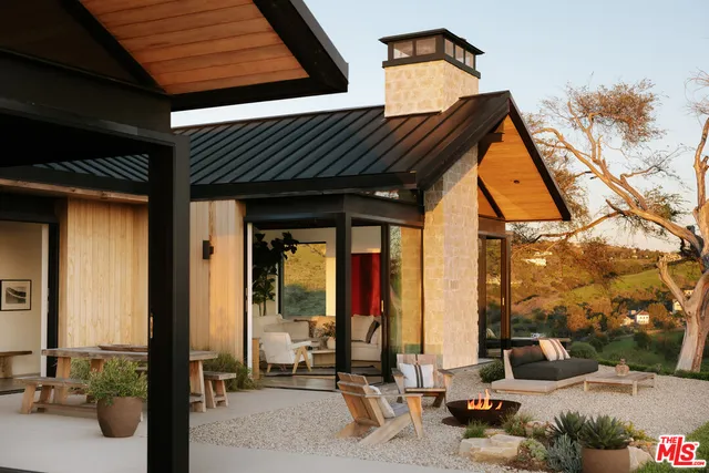 a building outdoor space with patio furniture and potted plants