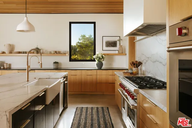 a kitchen that has a sink and a stove