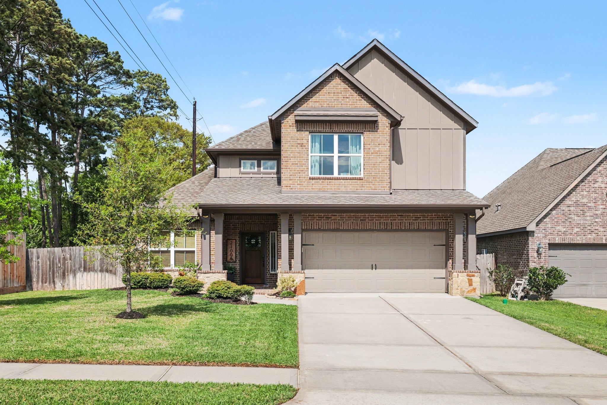 21006 Brave Legion Way Tomball, TX 77375 - Photo 1 of 29 a front view of a house with a yard and garage