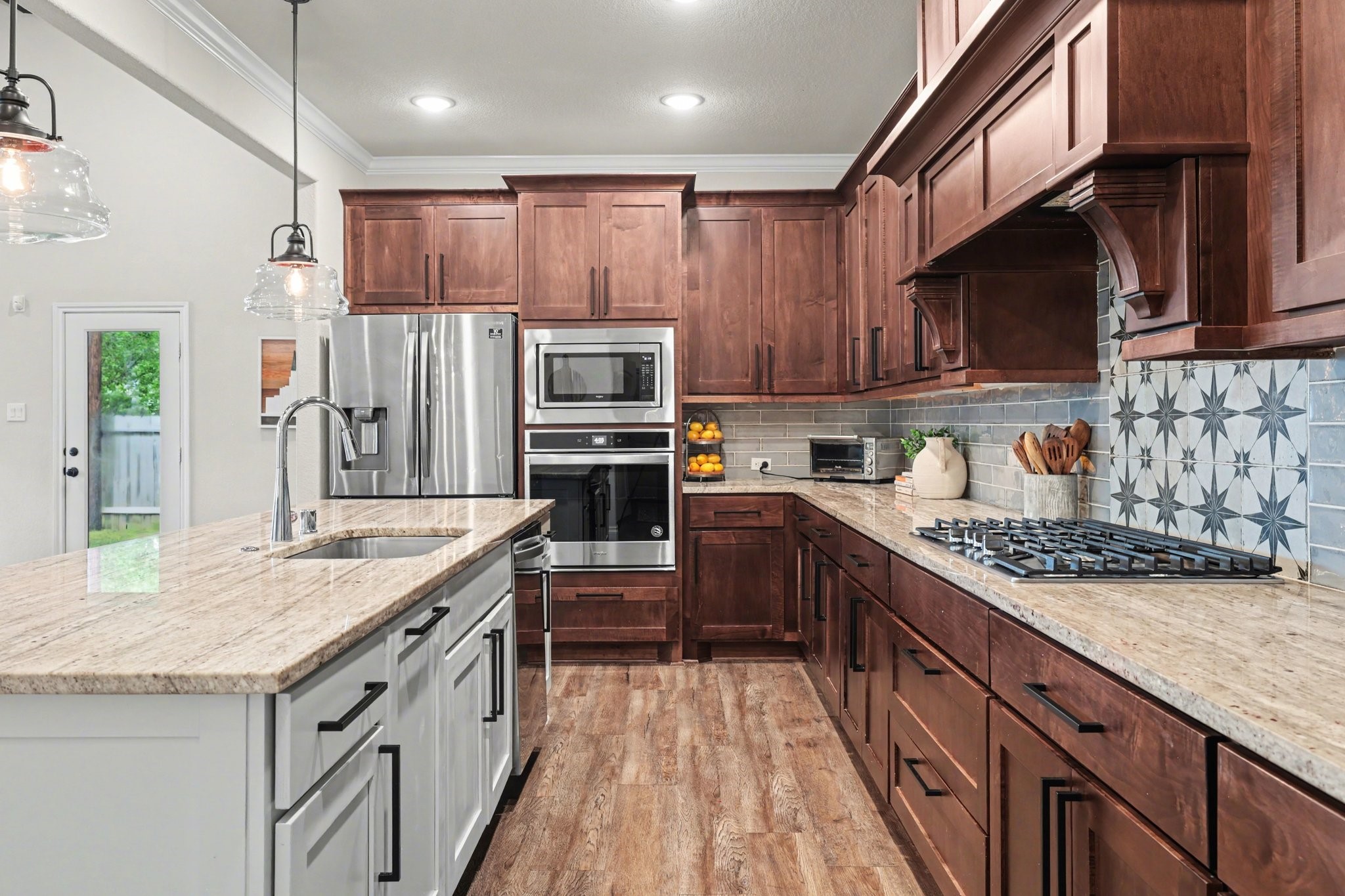 21006 Brave Legion Way Tomball, TX 77375 - Photo 13 of 29 a kitchen with stainless steel appliances granite countertop a stove a sink dishwasher a refrigerator and a oven with wooden floor