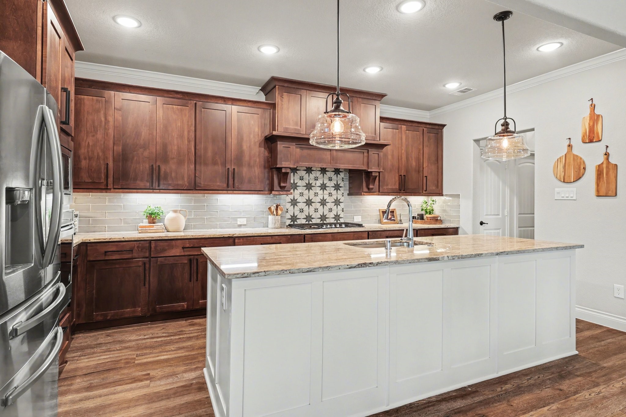 21006 Brave Legion Way Tomball, TX 77375 - Photo 14 of 29 a kitchen with kitchen island granite countertop a sink a counter space appliances and cabinets