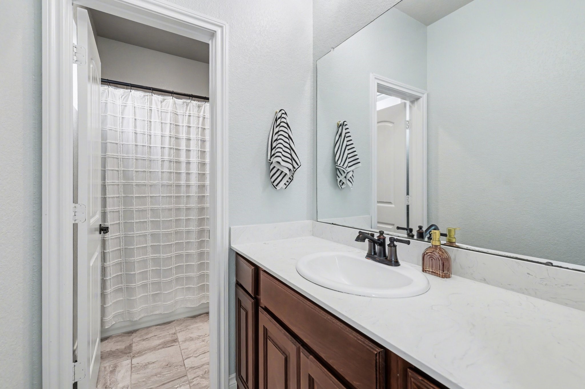 21006 Brave Legion Way Tomball, TX 77375 - Photo 23 of 29 a bathroom with a sink and a mirror