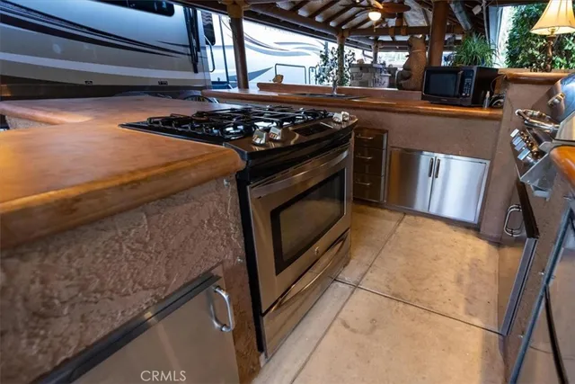 a stove top oven sitting inside of a kitchen