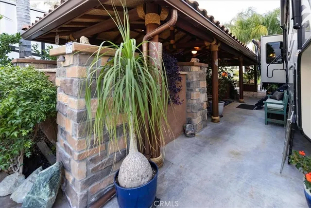 a backyard of a house with barbeque oven table and chairs