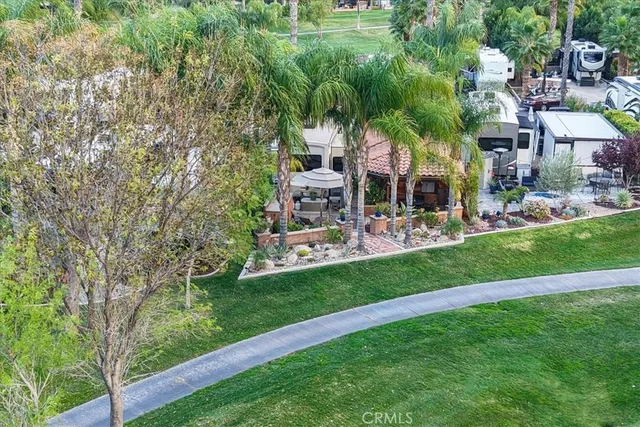 a front view of a house with a garden and sitting area