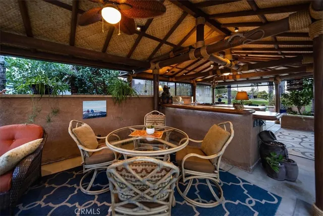 a dining room with furniture and a floor to ceiling window