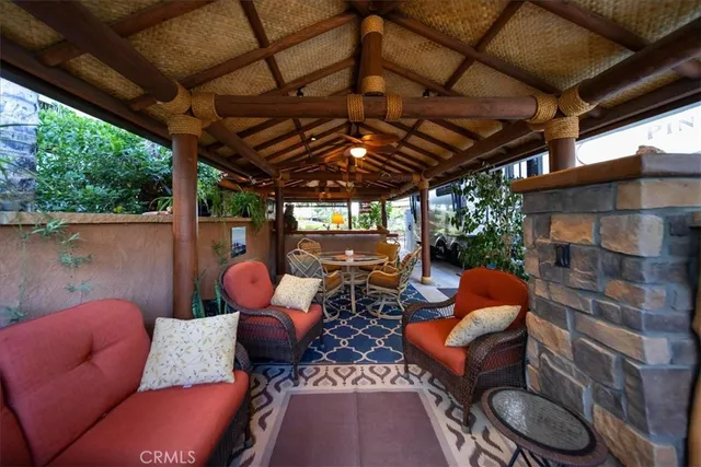 a outdoor living space with patio fireplace and furniture