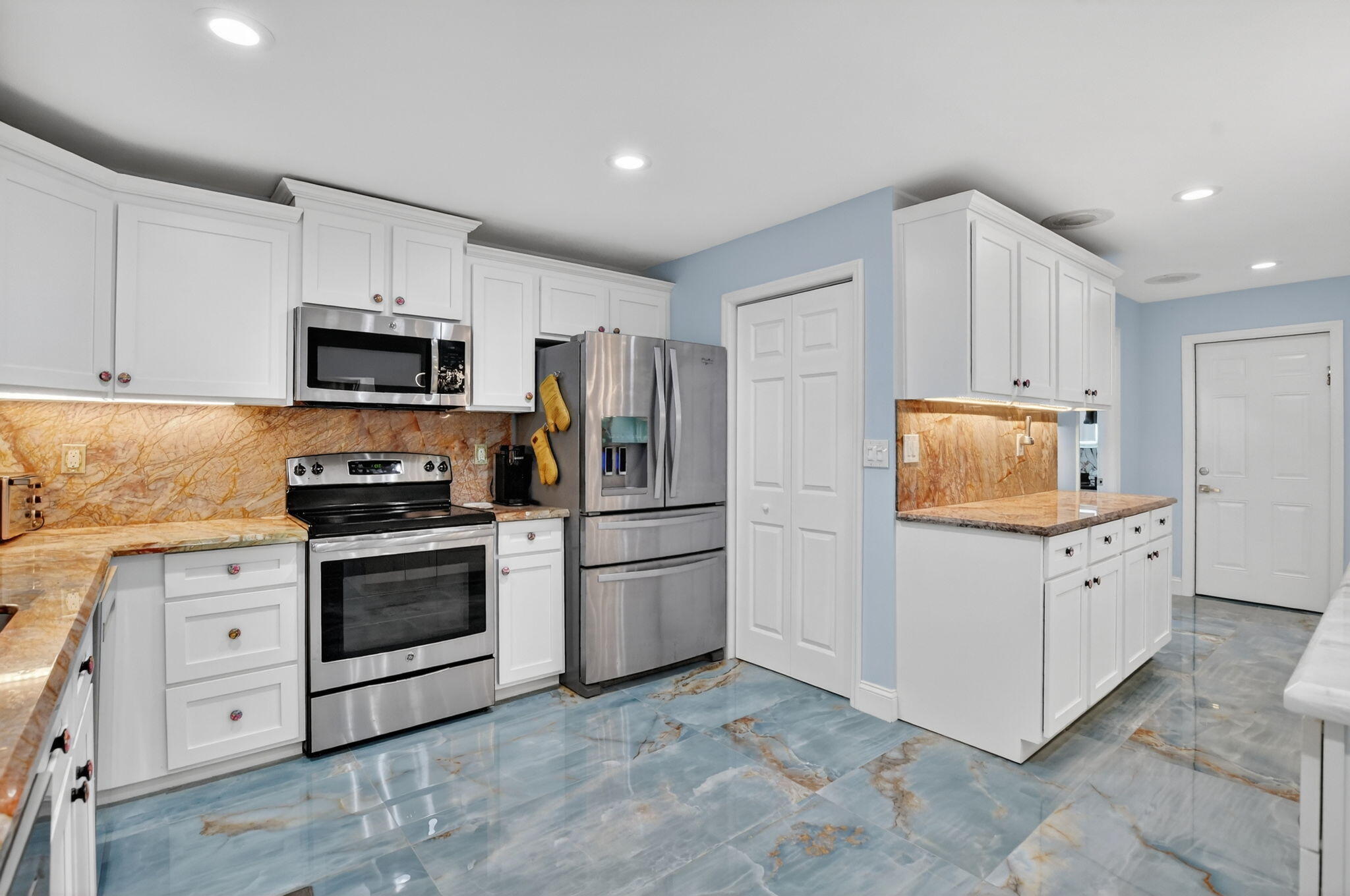 10294 Crosswind Road Boca Raton, FL 33498 - Photo 17 of 71 a kitchen with granite countertop a refrigerator stove and sink