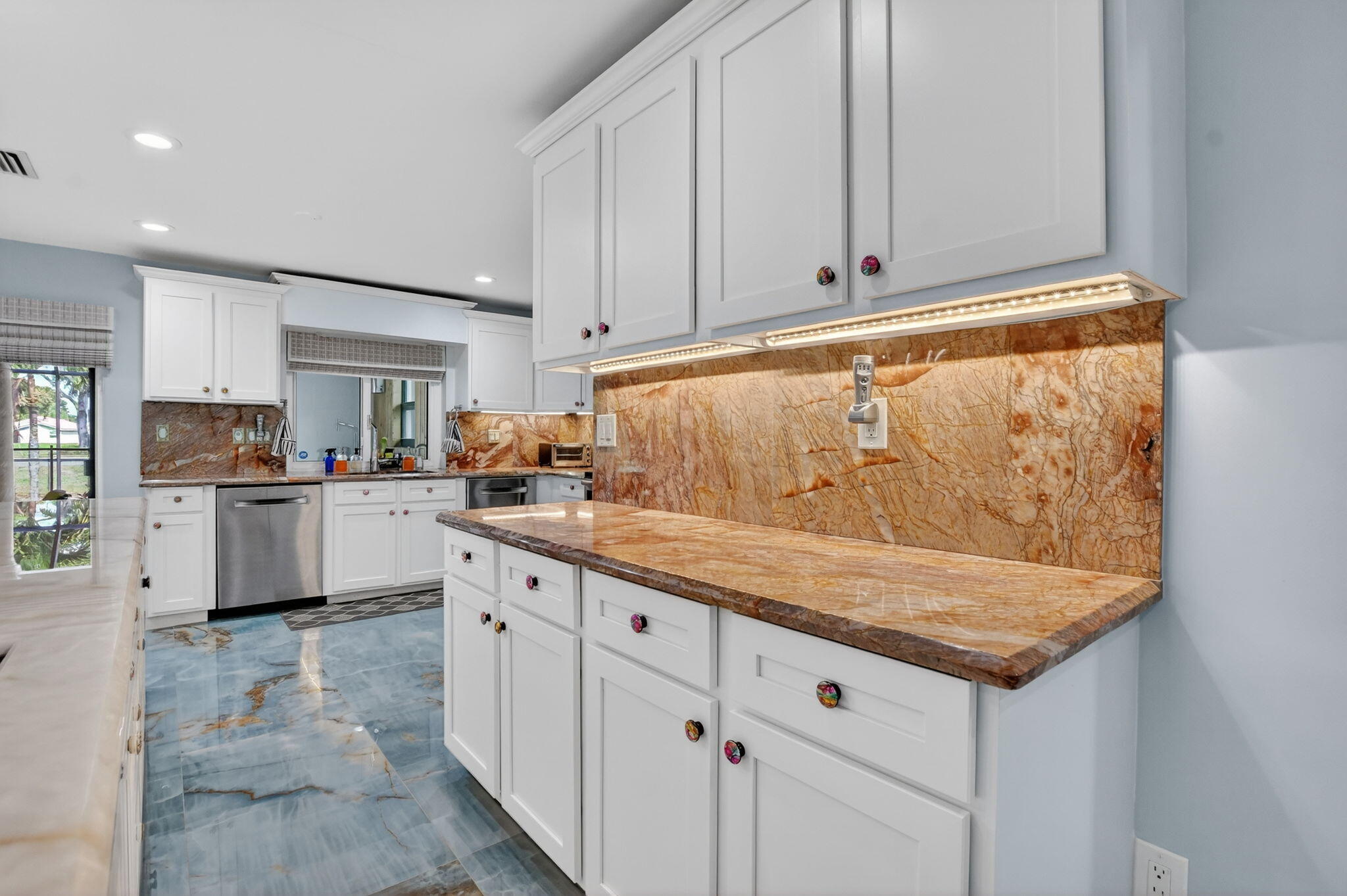 10294 Crosswind Road Boca Raton, FL 33498 - Photo 21 of 71 a kitchen with granite countertop white cabinets and white appliances