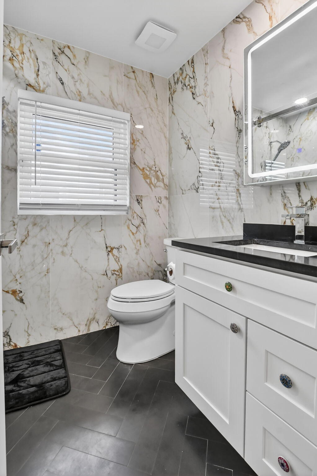 10294 Crosswind Road Boca Raton, FL 33498 - Photo 23 of 71 a bathroom with a toilet a sink and a window