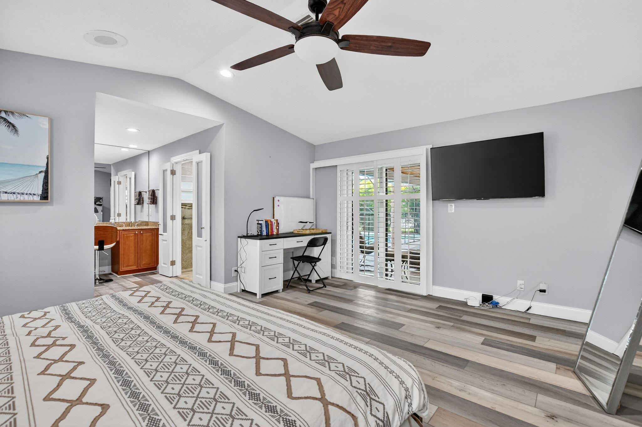 10294 Crosswind Road Boca Raton, FL 33498 - Photo 26 of 71 a spacious bedroom with a bed and a flat screen tv