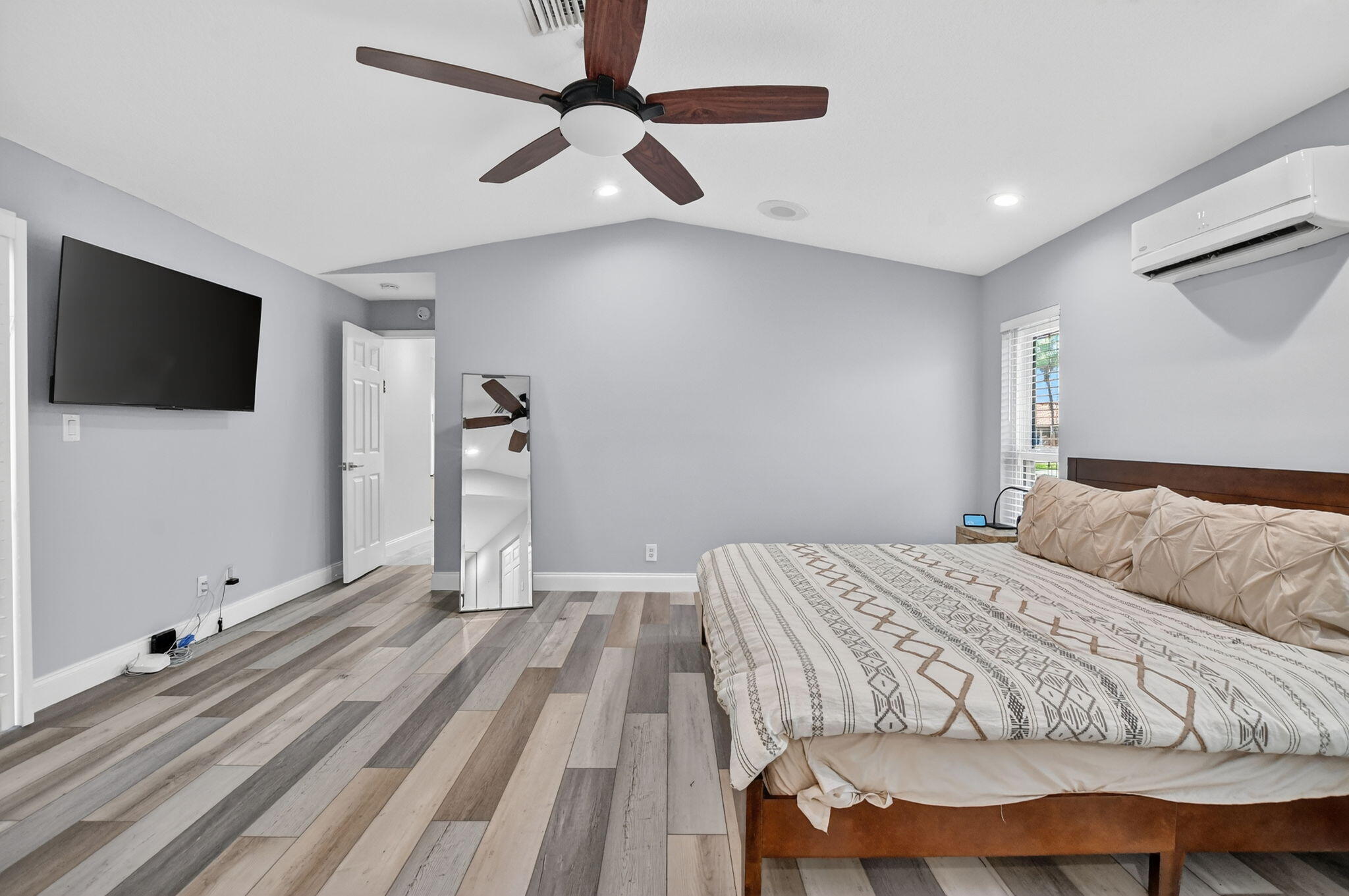 10294 Crosswind Road Boca Raton, FL 33498 - Photo 27 of 71 a bedroom with a bed and a flat screen tv