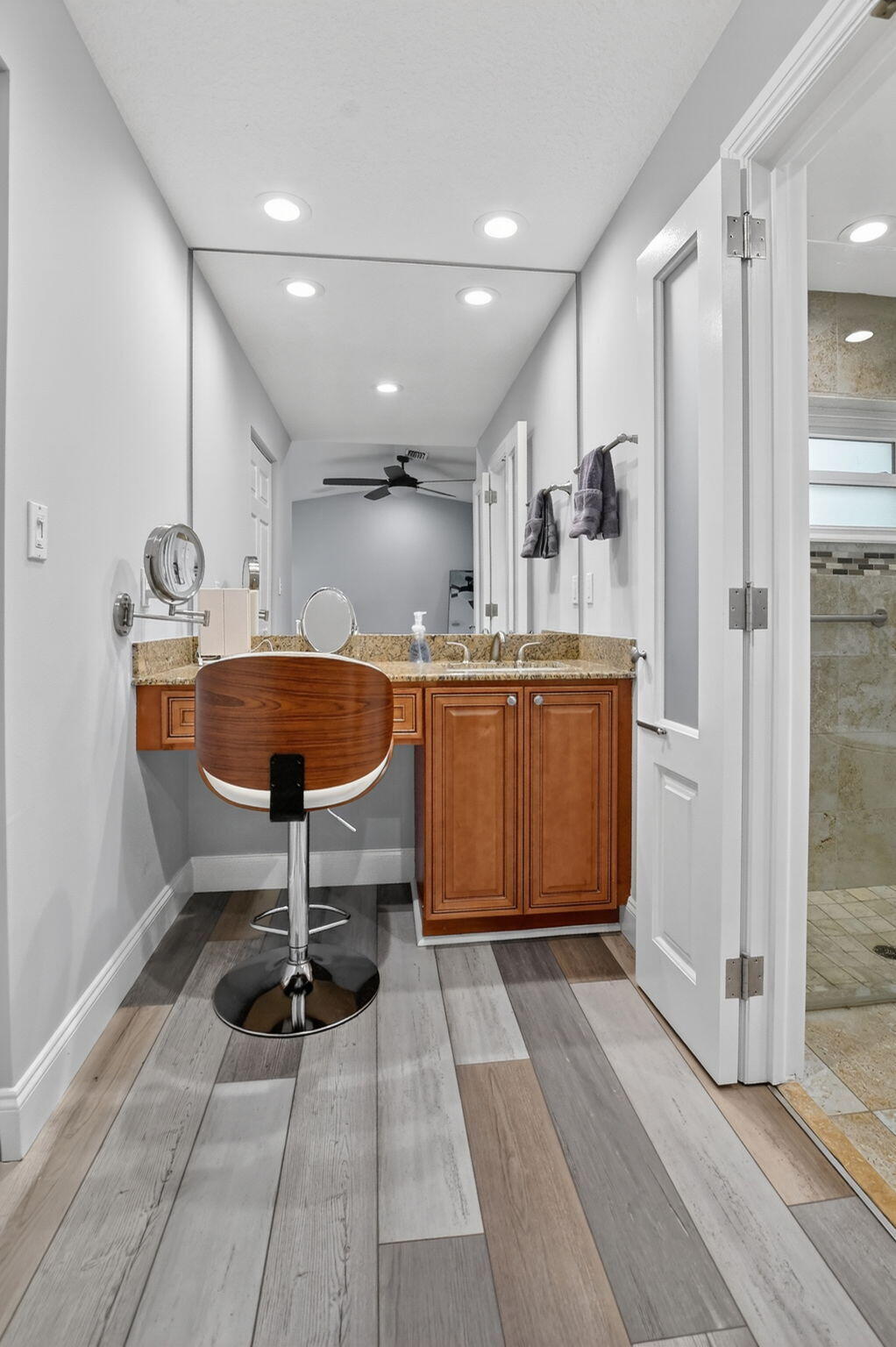 10294 Crosswind Road Boca Raton, FL 33498 - Photo 29 of 71 a kitchen with stainless steel appliances kitchen island granite countertop a sink and cabinets