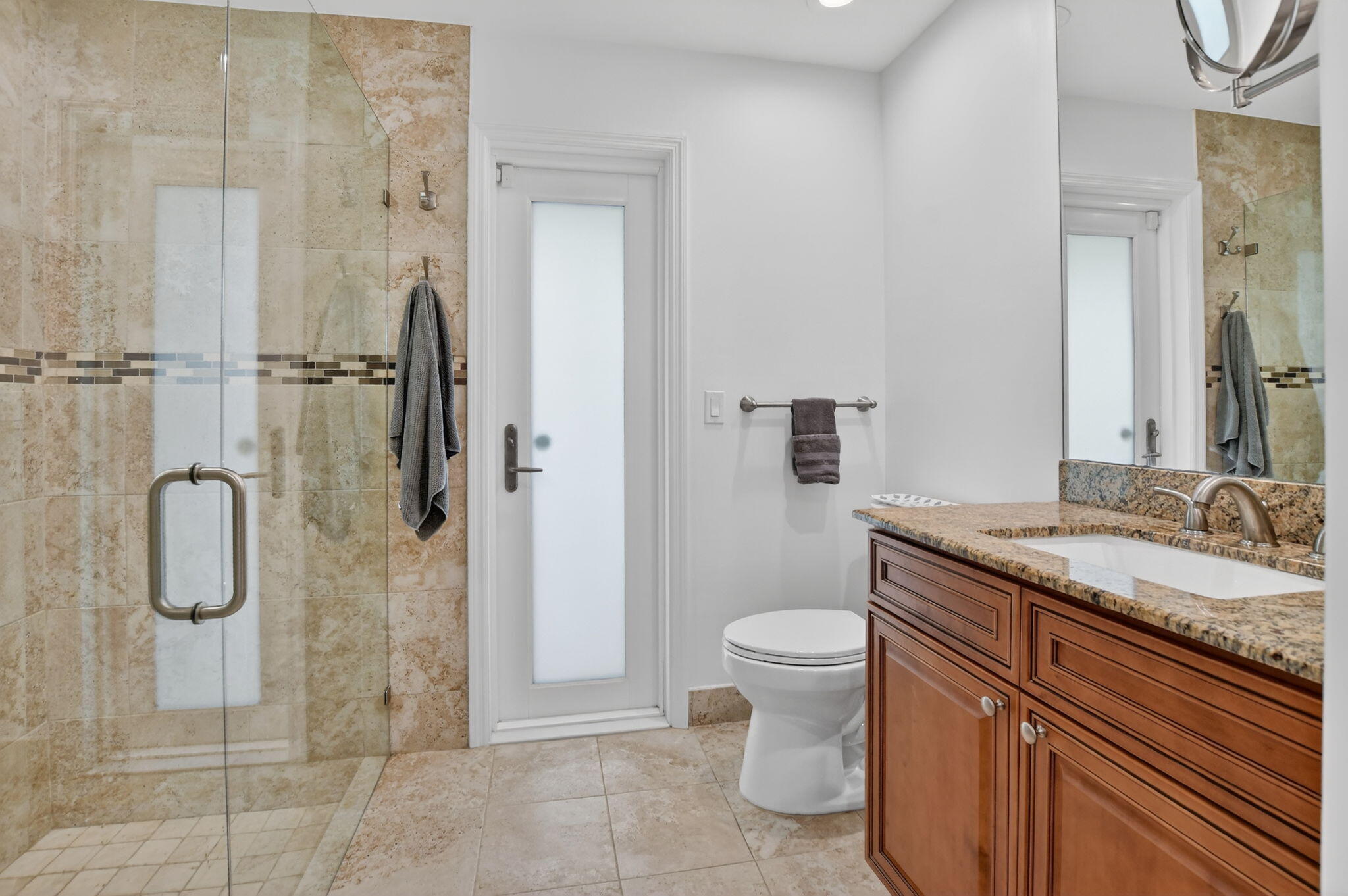 10294 Crosswind Road Boca Raton, FL 33498 - Photo 32 of 71 a bathroom with a granite countertop shower sink vanity and toilet