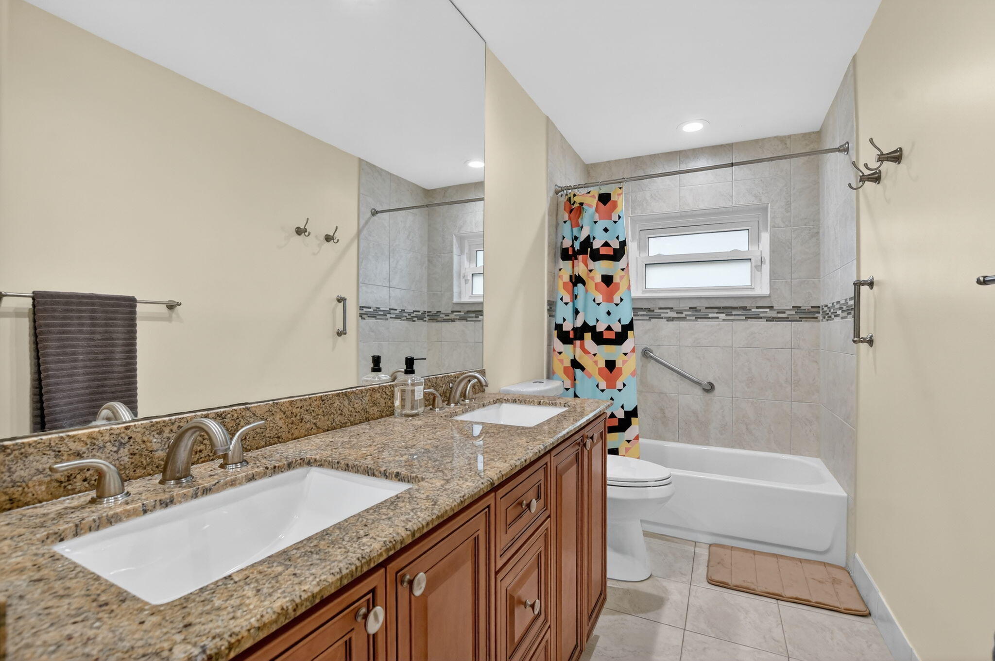 10294 Crosswind Road Boca Raton, FL 33498 - Photo 39 of 71 a bathroom with a granite countertop sink mirror and a bathtub