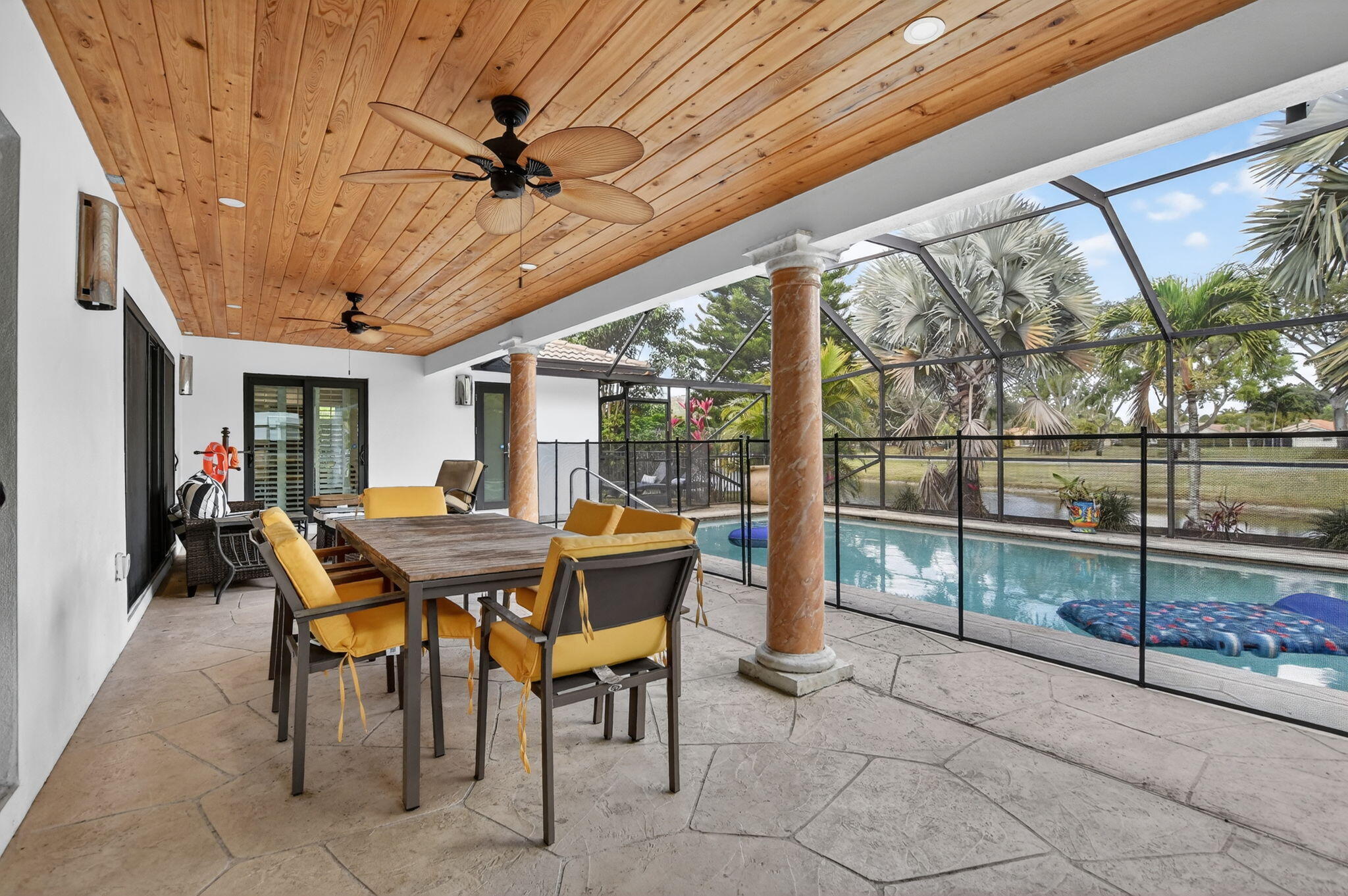 10294 Crosswind Road Boca Raton, FL 33498 - Photo 44 of 71 a view of a patio with a table and chairs