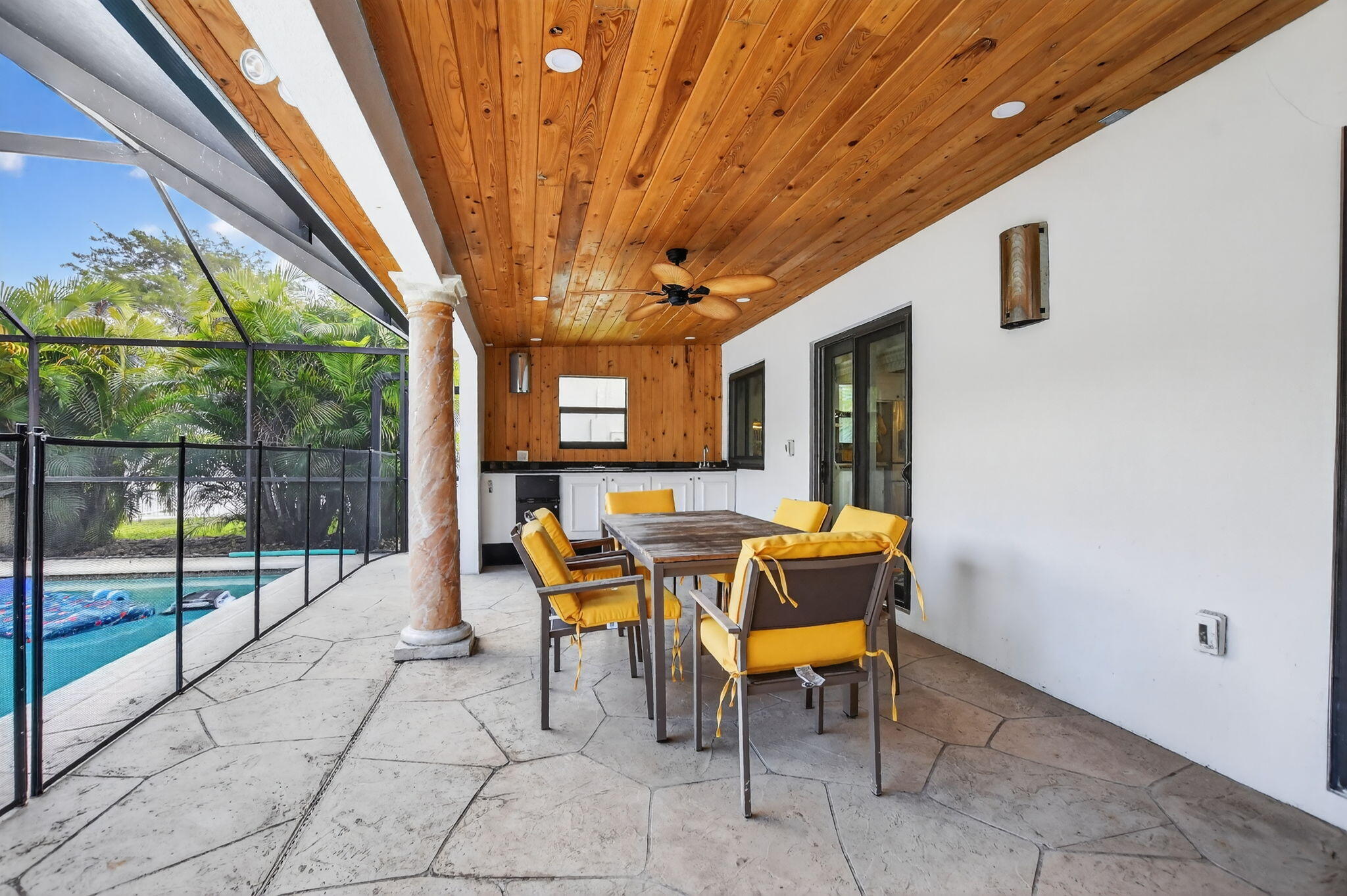 10294 Crosswind Road Boca Raton, FL 33498 - Photo 48 of 71 a view of a patio with table and chairs with wooden floor and fence