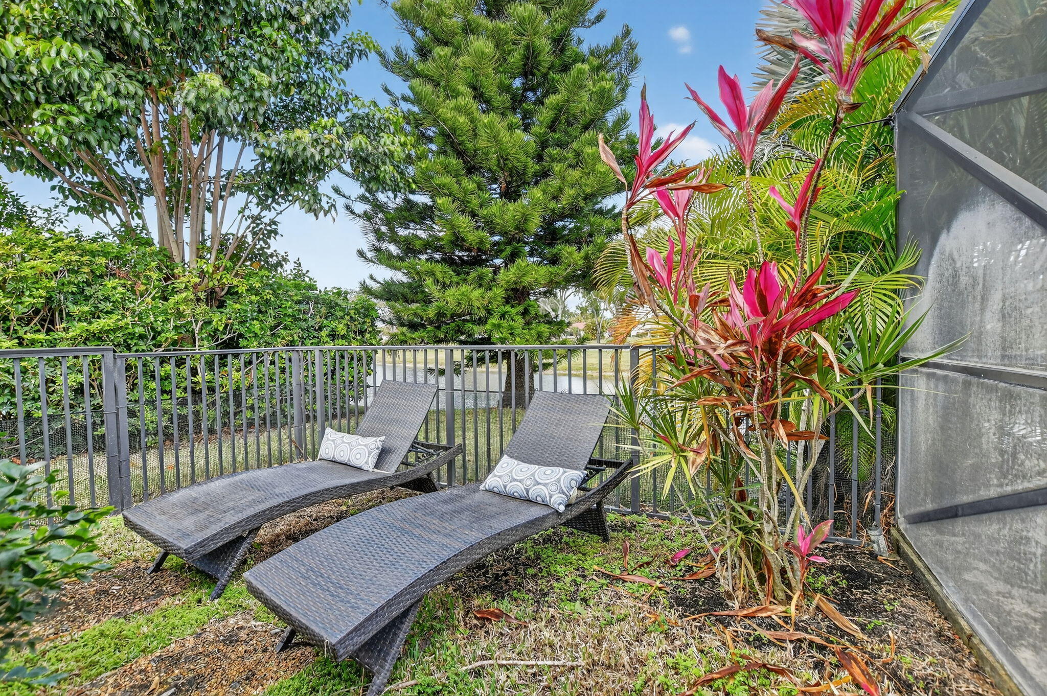 10294 Crosswind Road Boca Raton, FL 33498 - Photo 52 of 71 a view of a chair and table in the backyard
