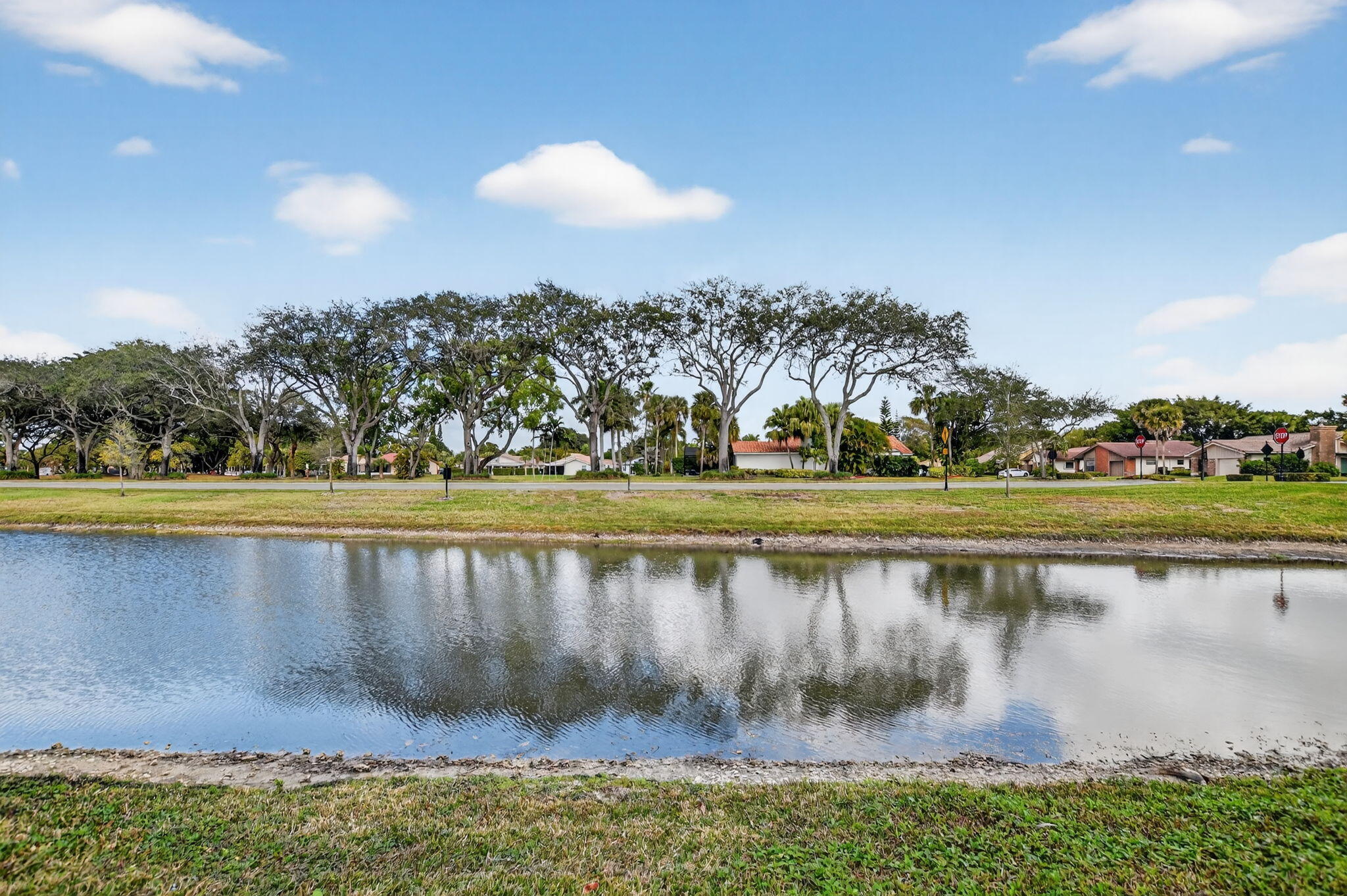 10294 Crosswind Road Boca Raton, FL 33498 - Photo 56 of 71 a view of a lake with a big yard
