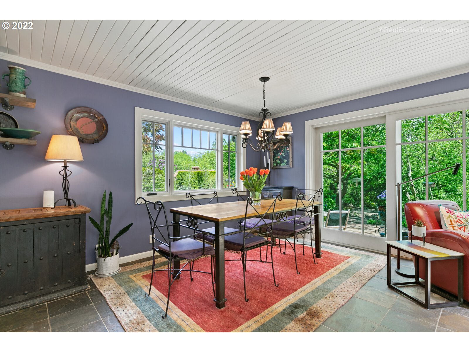9125 Southwest Rambler Lane Portland, OR 97223 - Photo 12 of 32 a dining room with furniture a rug a potted plant and a chandelier