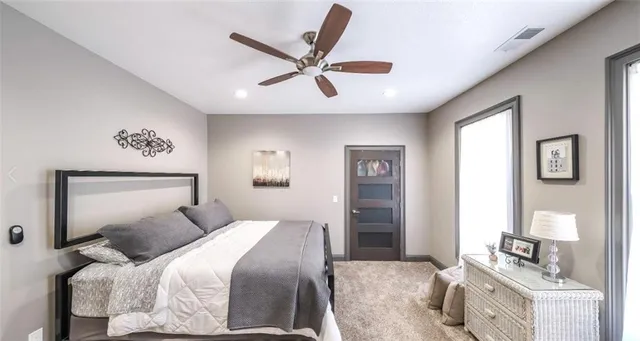 a en suite bathroom with a granite countertop sink and a mirror