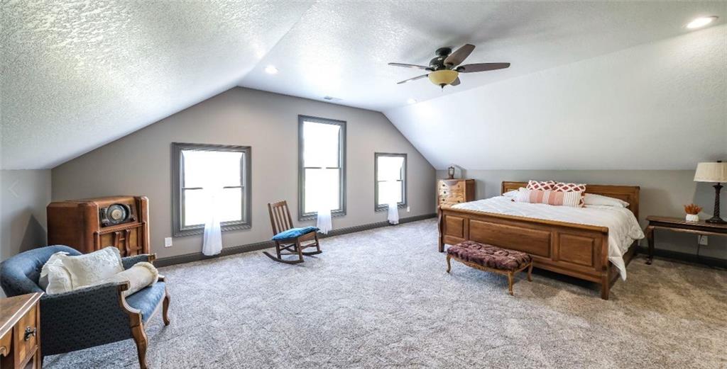 1600 Happy Hollow Road Roopville, GA 30170 - Photo 14 of 41 a bedroom with a bed and a chandelier