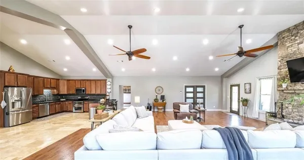 a kitchen with stainless steel appliances granite countertop a sink refrigerator and cabinets